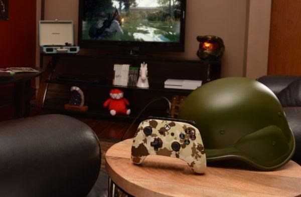 Camouflage design Enhanced Wired Controller next to army helmet