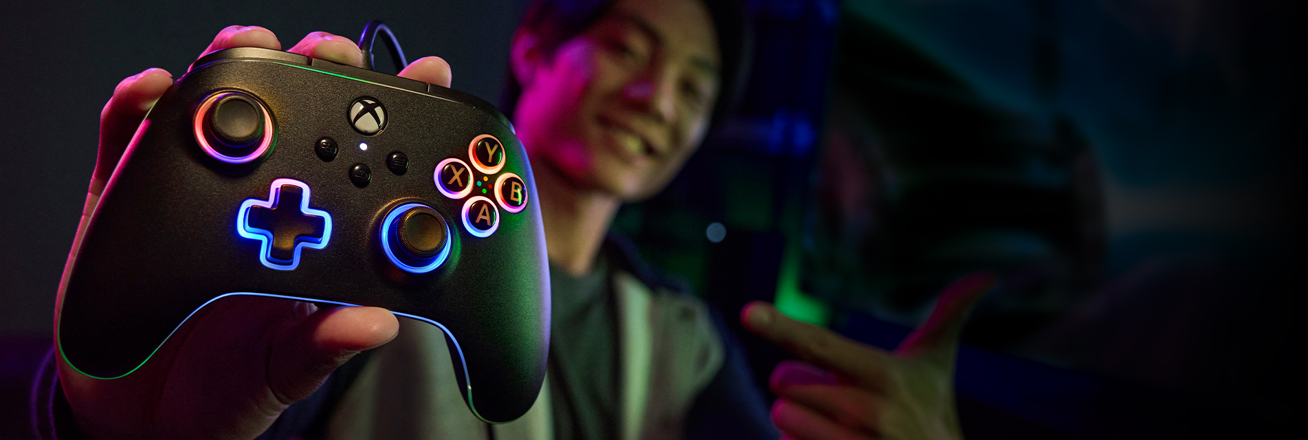 A gamer holding a glowing Lumectra controller on a dark background