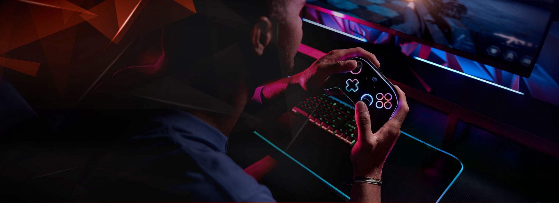 Guy plays a pc game with a glowing PowerA OPS controller