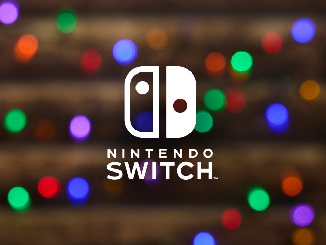 Nintendo Switch logo on a background of warm glowy holiday lights