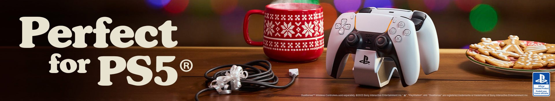 Twin Charging Station for DualSense Wireless Controllers on a table with gingerbread cookies and a steaming mug of something festive.